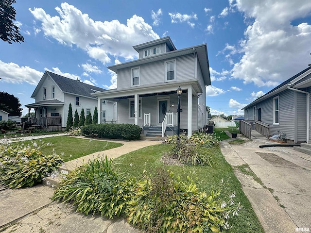 1426 32nd St, Rock Island, IL 61201 - american foursquare style home with a porch and a front lawn