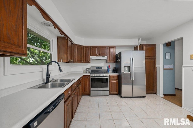 2917 W 65th St, Davenport, IA 52806 - kitchen featuring stainless steel appliances, under cabinet range hood, light countertops, and light tile patterned floors