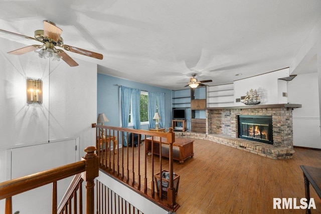 2917 W 65th St, Davenport, IA 52806 - living room with a ceiling fan, a fireplace, and wood finished floors