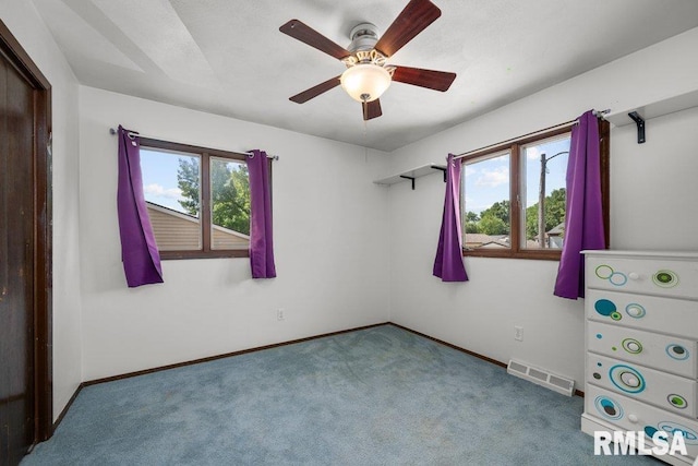 2917 W 65th St, Davenport, IA 52806 - unfurnished bedroom with carpet flooring and ceiling fan