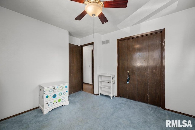 2917 W 65th St, Davenport, IA 52806 - unfurnished bedroom featuring carpet floors, a closet, and ceiling fan