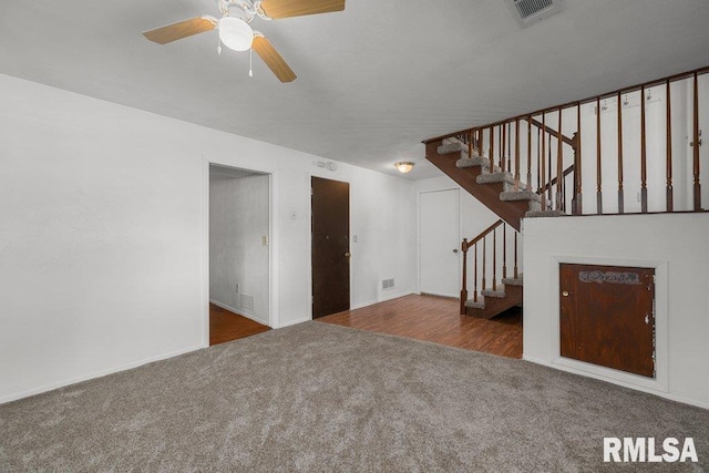 2917 W 65th St, Davenport, IA 52806 - unfurnished living room with carpet floors, a ceiling fan, and stairs