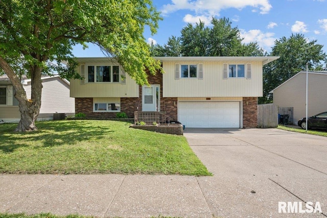 2917 W 65th St, Davenport, IA 52806 - raised ranch featuring an attached garage, driveway, a front lawn, and brick siding