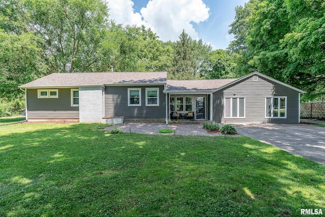 1715 65th Ave W, Rock Island, IL 61201 - rear view of house featuring a lawn, driveway, and a patio area