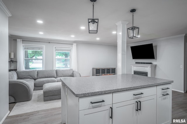 1715 65th Ave W, Rock Island, IL 61201 - kitchen with open floor plan, ornamental molding, wood finished floors, recessed lighting, and white cabinets