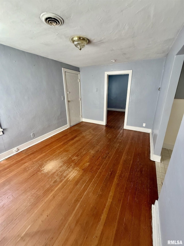 304 E Ames St, Yates City, IL 61572 - empty room with hardwood / wood-style flooring and baseboards