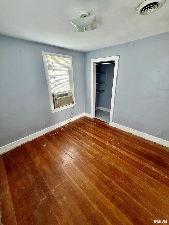 304 E Ames St, Yates City, IL 61572 - unfurnished bedroom with hardwood / wood-style flooring and cooling unit