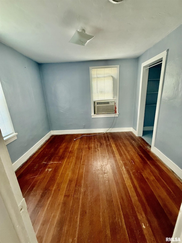 304 E Ames St, Yates City, IL 61572 - spare room with wood-type flooring and cooling unit