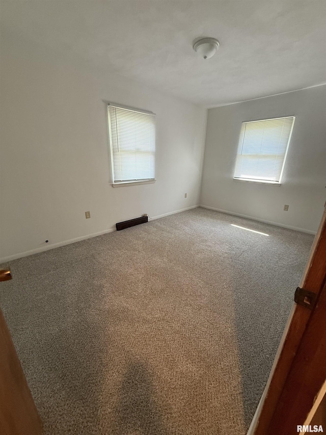 302 E Ames St, Yates City, IL 61572 - carpeted spare room featuring baseboards
