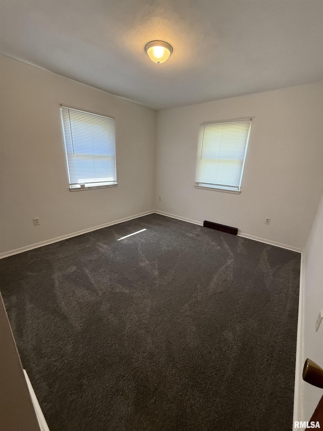 302 E Ames St, Yates City, IL 61572 - spare room with dark carpet and baseboards