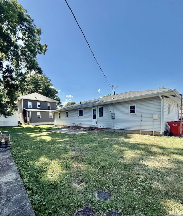 302 E Ames St, Yates City, IL 61572 - back of house featuring a lawn and a patio
