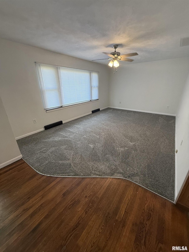 302 E Ames St, Yates City, IL 61572 - unfurnished room featuring a ceiling fan, wood finished floors, and carpet