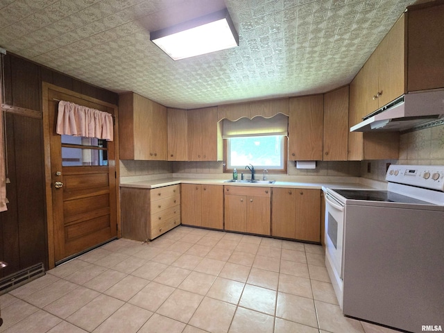 507 S Church St, Albany, IL 61230 - kitchen featuring white electric stove, under cabinet range hood, an ornate ceiling, light countertops, and light tile patterned flooring