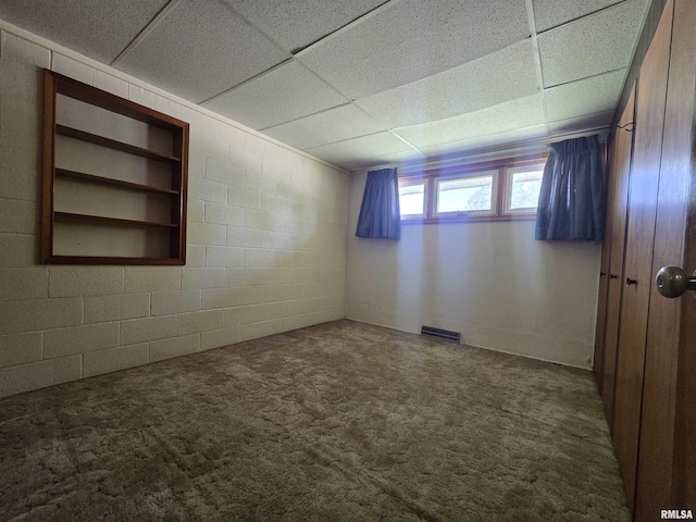 507 S Church St, Albany, IL 61230 - empty room featuring a drop ceiling, carpet, and concrete block wall