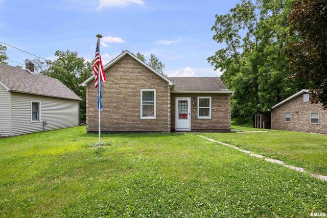404 5th St, Sherrard, IL 61281 - bungalow-style house with a front yard, roof with shingles, and brick siding