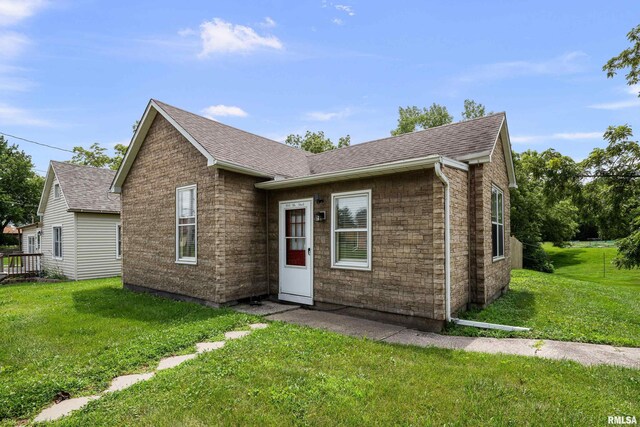 404 5th St, Sherrard, IL 61281 - view of front of home with a front yard and roof with shingles
