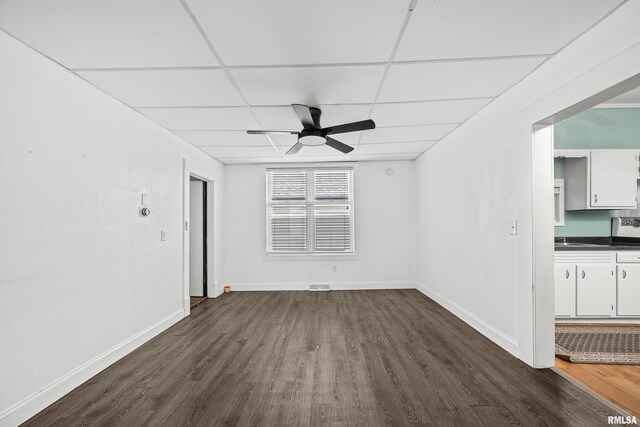 404 5th St, Sherrard, IL 61281 - unfurnished room with a paneled ceiling, dark wood-type flooring, and ceiling fan