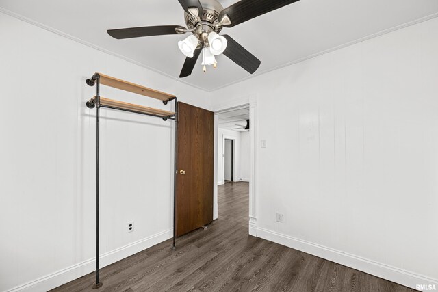 404 5th St, Sherrard, IL 61281 - unfurnished bedroom with dark wood-type flooring, ceiling fan, and ornamental molding