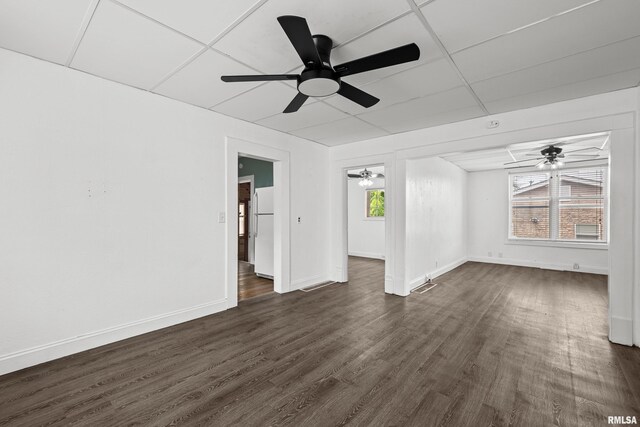 404 5th St, Sherrard, IL 61281 - empty room with ceiling fan, dark wood-style floors, and healthy amount of natural light