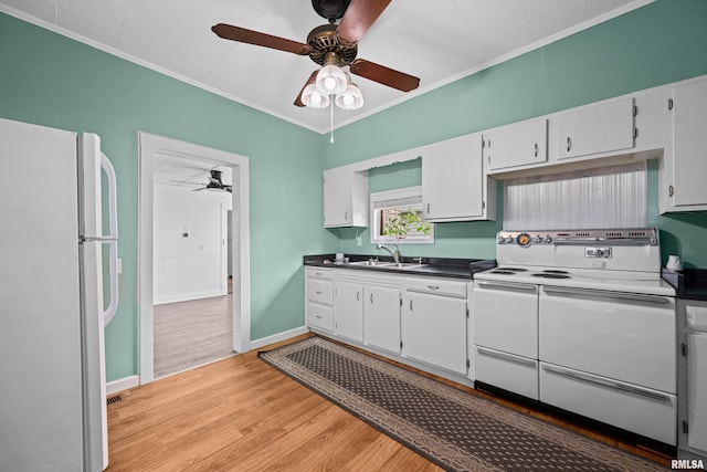 404 5th St, Sherrard, IL 61281 - kitchen featuring white appliances, a ceiling fan, crown molding, dark countertops, and light wood-type flooring
