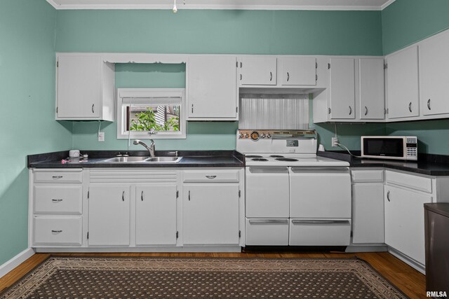 404 5th St, Sherrard, IL 61281 - kitchen with white appliances, dark wood-type flooring, white cabinetry, and dark countertops