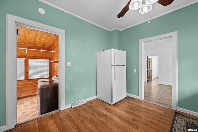 404 5th St, Sherrard, IL 61281 - spare room with washer / dryer, a ceiling fan, wood finished floors, and crown molding