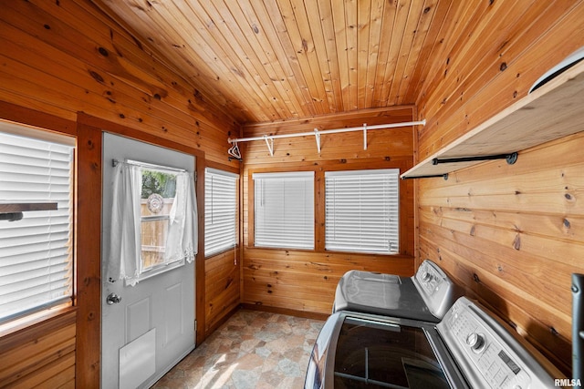 404 5th St, Sherrard, IL 61281 - laundry area with washing machine and dryer, wooden walls, light stone finish floors, and wooden ceiling