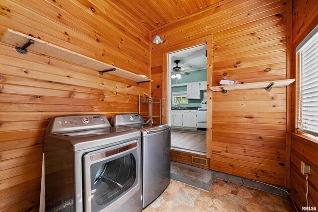 404 5th St, Sherrard, IL 61281 - laundry room with separate washer and dryer, wood walls, stone finish flooring, a ceiling fan, and wooden ceiling