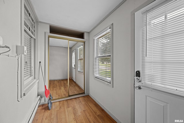 404 5th St, Sherrard, IL 61281 - entryway with light wood-type flooring and a baseboard heating unit
