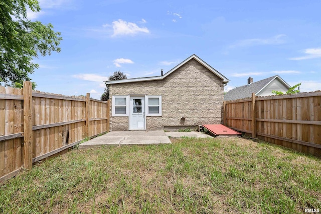 404 5th St, Sherrard, IL 61281 - rear view of property featuring a fenced backyard, a patio, and stone siding