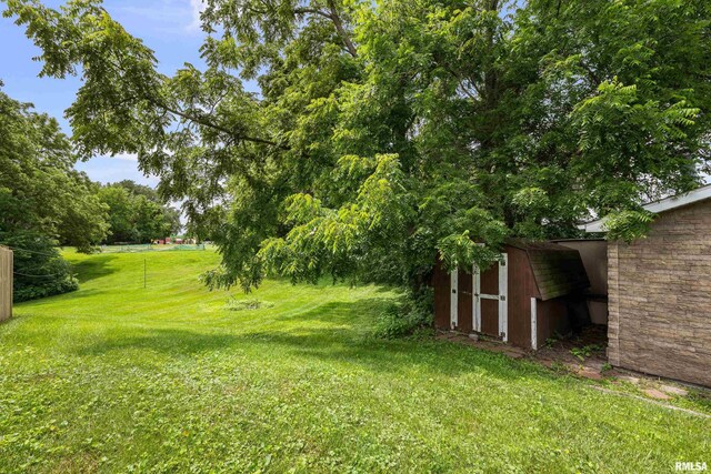 404 5th St, Sherrard, IL 61281 - view of green lawn featuring a storage unit