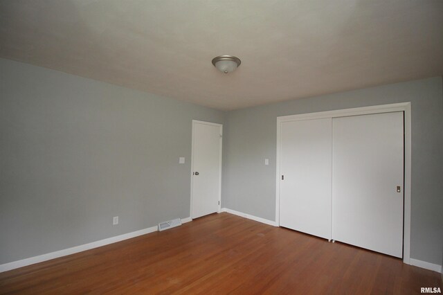 1524 W 4th St, Milan, IL 61264 - unfurnished bedroom with wood finished floors and a closet