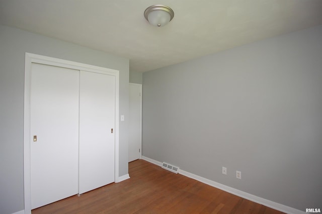 1524 W 4th St, Milan, IL 61264 - unfurnished bedroom with wood finished floors and a closet