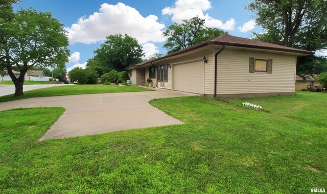 1524 W 4th St, Milan, IL 61264 - rear view of property featuring an attached garage, a yard, and concrete driveway