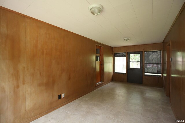 1524 W 4th St, Milan, IL 61264 - spare room featuring wood walls and tile patterned flooring