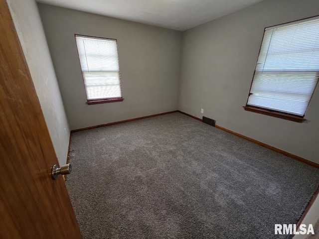1405 26th St, Rock Island, IL 61201 - carpeted empty room featuring baseboards