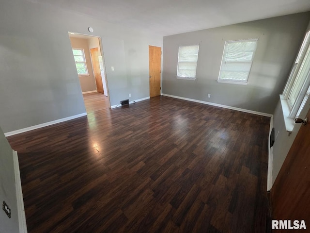 1405 26th St, Rock Island, IL 61201 - spare room with dark wood-type flooring and baseboards