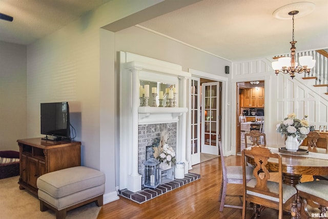 214 N Chestnut St, Mendon, IL 62351 - dining area featuring wood finished floors, stairs, and a chandelier
