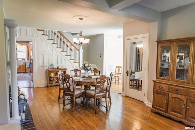 214 N Chestnut St, Mendon, IL 62351 - dining area featuring light wood-style floors, a chandelier, and stairway