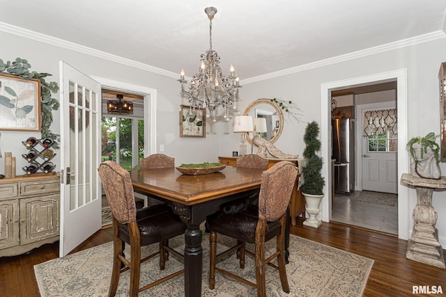 3205 Crestline Dr, Davenport, IA 52803 - dining space with a chandelier, crown molding, and dark wood-type flooring