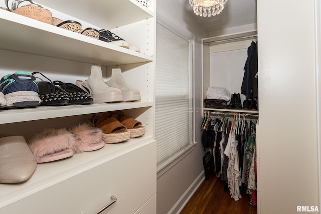 3205 Crestline Dr, Davenport, IA 52803 - walk in closet featuring dark wood-style floors and a chandelier