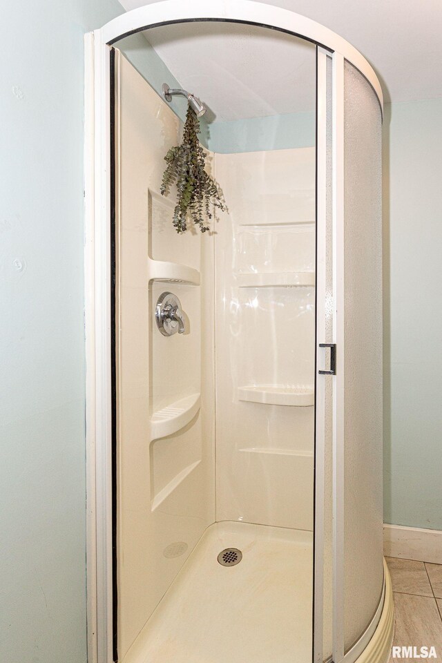 3205 Crestline Dr, Davenport, IA 52803 - full bathroom with a stall shower and baseboards
