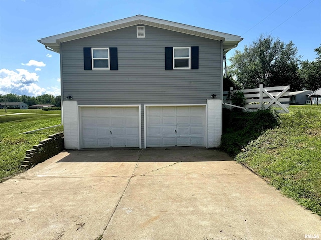 202 S 10th Ave, New Windsor, IL 61465 - view of property exterior featuring an attached garage, concrete driveway, and brick siding