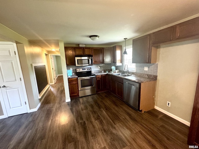 202 S 10th Ave, New Windsor, IL 61465 - kitchen featuring stainless steel appliances, decorative backsplash, dark wood-style floors, and pendant lighting