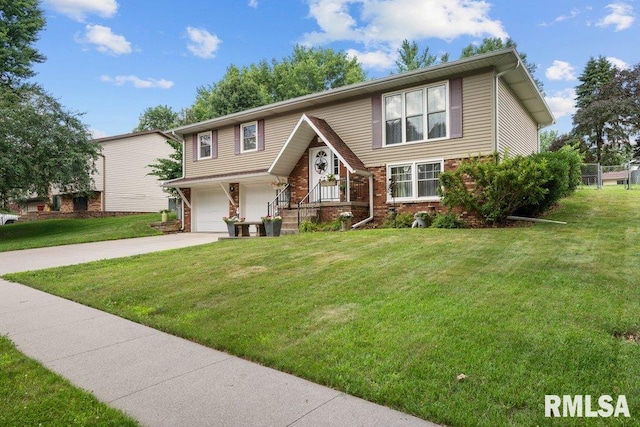 833 Robin Rd, Muscatine, IA 52761 - bi-level home with concrete driveway, brick siding, a front yard, and an attached garage