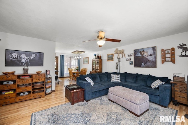 833 Robin Rd, Muscatine, IA 52761 - living room with ceiling fan, light wood-style floors, and a chandelier