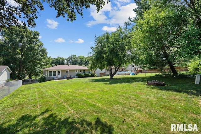 833 Robin Rd, Muscatine, IA 52761 - fenced backyard with an outdoor fire pit