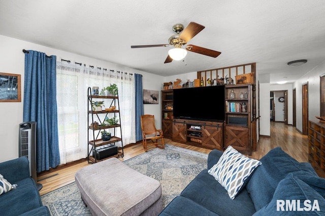 833 Robin Rd, Muscatine, IA 52761 - living room with wood finished floors and ceiling fan