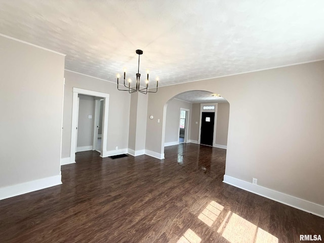 2111 Pine St, Murphysboro, IL 62966 - spare room with arched walkways, a chandelier, dark wood-style floors, and crown molding