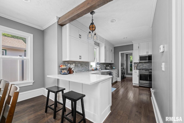 1309 5th St, Orion, IL 61273 - kitchen with stainless steel appliances, dark wood-style floors, decorative backsplash, white cabinetry, and healthy amount of natural light